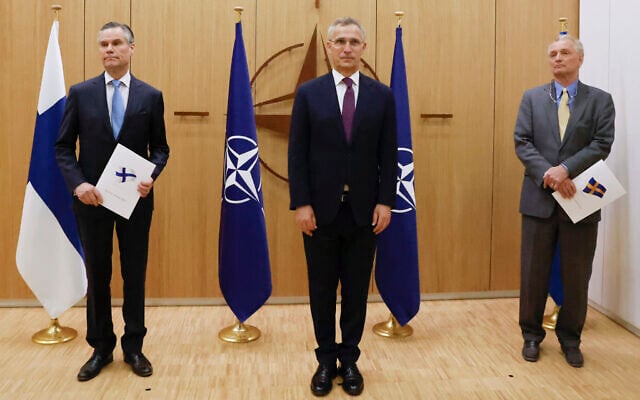 Finland's Ambassador to NATO Klaus Korhonen, left, NATO Secretary-General Jens Stoltenberg and Sweden's Ambassador to NATO Axel Wernhoff attend a ceremony to mark Sweden's and Finland's application for membership in Brussels, Belgium, May 18, 2022. (Johanna Geron/Pool via AP) Finland's Ambassador to NATO Klaus Korhonen, left, NATO Secretary-General Jens Stoltenberg and Sweden's Ambassador to NATO Axel Wernhoff attend a ceremony to mark Sweden's and Finland's application for membership in Brussels, Belgium, May 18, 2022. (Johanna Geron/Pool via AP)