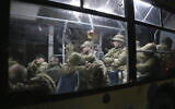 Ukrainian servicemen sit in a bus after leaving Mariupol's besieged Azovstal steel plant, near a penal colony, in Olyonivka, in territory under the government of the Donetsk People's Republic, eastern Ukraine, Friday, May 20, 2022. (AP Photo)