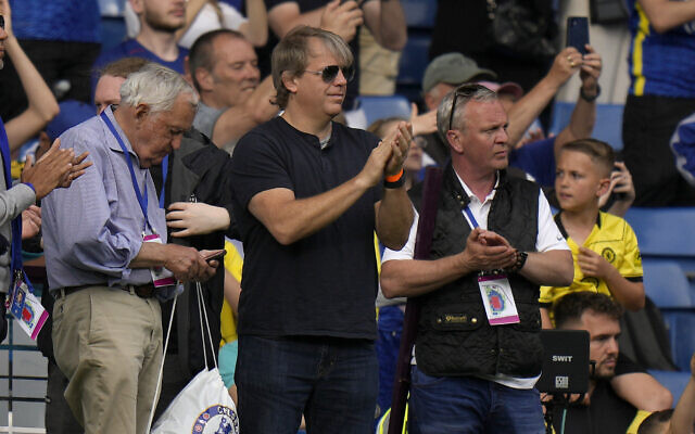 American businessman Todd Boehly (center) applauds as he attends the English Premier League soccer match between Chelsea and Watford at Stamford Bridge stadium in London, May 22, 2022. (AP/Alastair Grant) American businessman Todd Boehly (center) applauds as he attends the English Premier League soccer match between Chelsea and Watford at Stamford Bridge stadium in London, May 22, 2022. (AP/Alastair Grant)