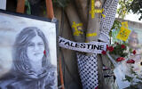 Yellow tape marks bullet holes on a tree and a portrait and flowers create a makeshift memorial at the site where Palestinian-American Al-Jazeera journalist Shireen Abu Akleh was shot and killed in the West Bank city of Jenin, on May 19, 2022. (AP/Majdi Mohammed)