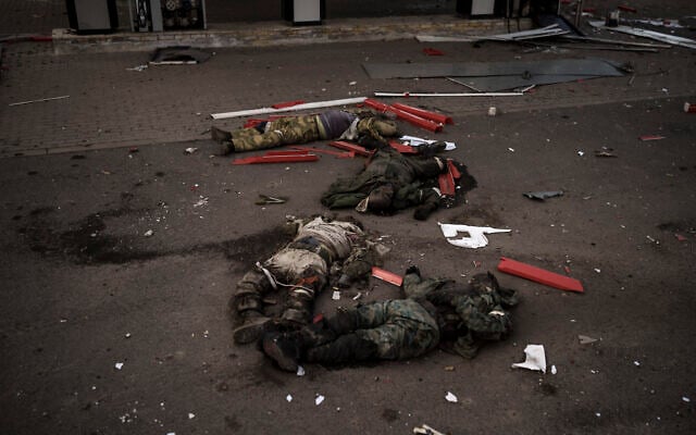 The bodies of unidentified men, believed to be Russian soldiers, arranged in a Z, a symbol of the Russian invasion, lie near a village recently retaken by Ukrainian forces on the outskirts of Kharkiv, Ukraine, May 2, 2022. (AP Photo/Felipe Dana, File)