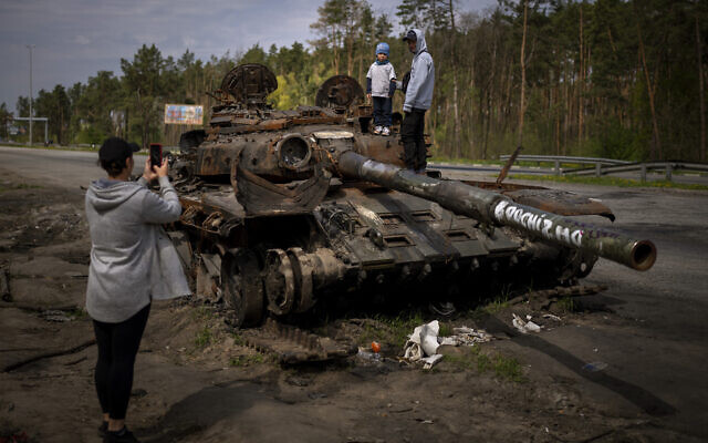 Maksym, 3, is photographed with his brother, Dmytro, 16, on top of a destroyed Russian tank, on the outskirts of Kyiv, Ukraine, May 8, 2022. (AP Photo/Emilio Morenatti, File) Maksym, 3, is photographed with his brother, Dmytro, 16, on top of a destroyed Russian tank, on the outskirts of Kyiv, Ukraine, May 8, 2022. (AP Photo/Emilio Morenatti, File)