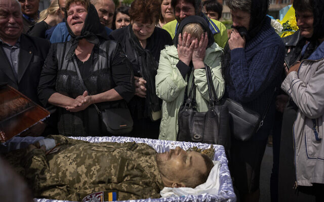 Relatives react next to the body of Oleksandr Pankratov, 49, a Ukrainian military serviceman who was killed in Donetsk province, during his funeral in Lviv, Ukraine, May 14, 2022. (AP Photo/Emilio Morenatti, file) Relatives react next to the body of Oleksandr Pankratov, 49, a Ukrainian military serviceman who was killed in Donetsk province, during his funeral in Lviv, Ukraine, May 14, 2022. (AP Photo/Emilio Morenatti, file)