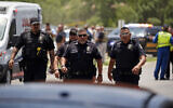 Police walk near Robb Elementary School following a shooting, May 24, 2022, in Uvalde, Texas. (AP Photo/Dario Lopez-Mills)
