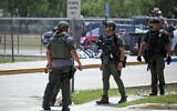 Law enforcement personnel stand outside Robb Elementary School following a shooting, Tuesday, May 24, 2022, in Uvalde, Texas. (AP Photo/Dario Lopez-Mills)