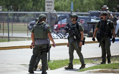 Law enforcement personnel stand outside Robb Elementary School following a shooting, Tuesday, May 24, 2022, in Uvalde, Texas. (AP Photo/Dario Lopez-Mills)