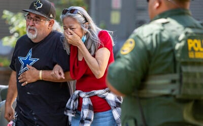 A woman cries as she leaves the Uvalde Civic Center, May 24, 2022, in Uvalde, Texas, following a deadly school shooting in the town. (William Luther/The San Antonio Express-News via AP)