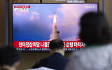 People watch a TV screen showing a news program reporting about North Korea's missile launch with file image, at a train station in Seoul, South Korea, May 25, 2022. (AP/Lee Jin-man)