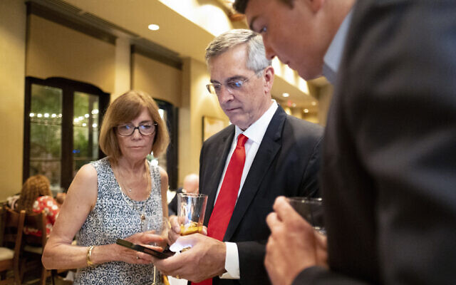 Incumbent Georgia Secretary of State Brad Raffensperger, checks returns with supporters during an election night party, May 24, 2022, at a small restaurant in Peachtree Corners, Georgia (AP Photo/Ben Gray) Incumbent Georgia Secretary of State Brad Raffensperger, checks returns with supporters during an election night party, May 24, 2022, at a small restaurant in Peachtree Corners, Georgia (AP Photo/Ben Gray)