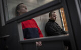 Russian soldiers Alexander Alexeevich Ivanov, right, and Alexander Vladimirovich Bobykin attend their trial hearing in Kotelva, northeastern Ukraine, May 26, 2022. (AP Photo/Bernat Armangue)