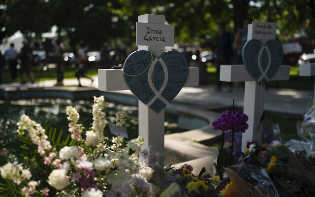 The cross at the gravesite of Irma Garcia, a teacher who was killed in this week's elementary school shooting. Her husband, Joe Garcia, died two days after the shooting. Thursday, May 26, 2022. (AP Photo/Jae C. Hong)