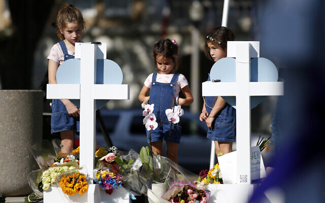 Children pay their respects at a memorial site for the victims killed in this week's elementary school shooting in Uvalde, Texas, Thursday, May 26, 2022. (AP Photo/Dario Lopez-Mills) Children pay their respects at a memorial site for the victims killed in this week's elementary school shooting in Uvalde, Texas, Thursday, May 26, 2022. (AP Photo/Dario Lopez-Mills)