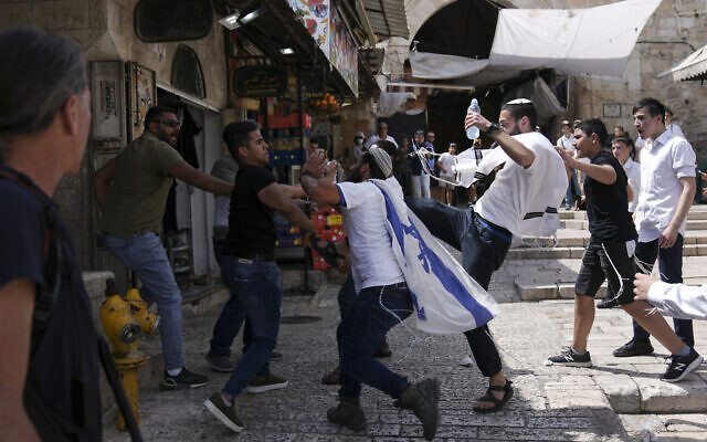 Palestinians and Jewish youths clash in Jerusalem's Old City as Israelis mark Jerusalem Day, an Israeli holiday celebrating the capture of the Old City during the 1967 Six-Day war, May 29, 2022. (AP Photo/Ariel Schalit) Palestinians and Jewish youths clash in Jerusalem's Old City as Israelis mark Jerusalem Day, an Israeli holiday celebrating the capture of the Old City during the 1967 Six-Day war, May 29, 2022. (AP Photo/Ariel Schalit)