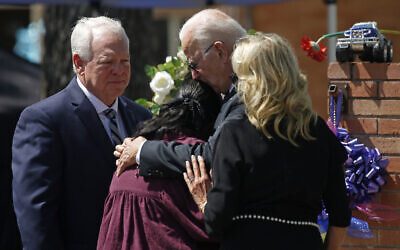 President Joe Biden and First Lady Jill Biden comfort Principal Mandy Gutierrez, as Superintendent Hal Harrell stands next to them, at a memorial outside Robb Elementary School to honor the victims killed in a school shooting in Uvalde, Texas, May 29, 2022. (AP Photo/Dario Lopez-Mills)