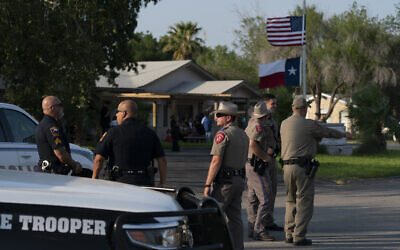 Law enforcement personnel stand outside a funeral home during a visitation for Amerie Garza, a 10-year-old victim who was killed in last week's elementary school shooting in Uvalde, Texas, Monday, May 30, 2022. (AP Photo/Jae C. Hong)