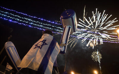 Illustrative: People watch fireworks during a show to mark Israel's 71st Independence Day in Jerusalem on May 8, 2019. For May 5, 2022's Independence Day, numerous municipalities scrapped fireworks displays out of concern for people with PTSD. (Hadas Parush/Flash90)