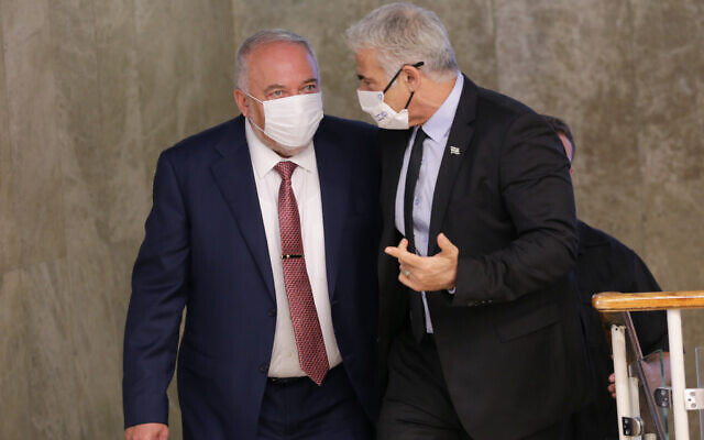 Foreign Minister Yair Lapid and Minister of Finance Avigdor Liberman arrive to a cabinet meeting at the Prime Minister's Office in Jerusalem on October 5, 2021.  Photo by Alex Kolomoisky/POOL ***POOL PICTURE, EDITORIAL USE ONLY/NO SALES, PLEASE CREDIT THE PHOTOGRAPHER AS WRITTEN - ALEX KOLOMOISKY/POOL***