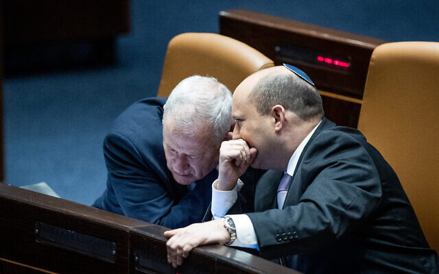 File: Prime Minister Naftali Bennett, right, with Minister of Defense Benny Gantz during a plenum session at the Knesset, on February 28, 2022. (Yonatan Sindel/Flash90)