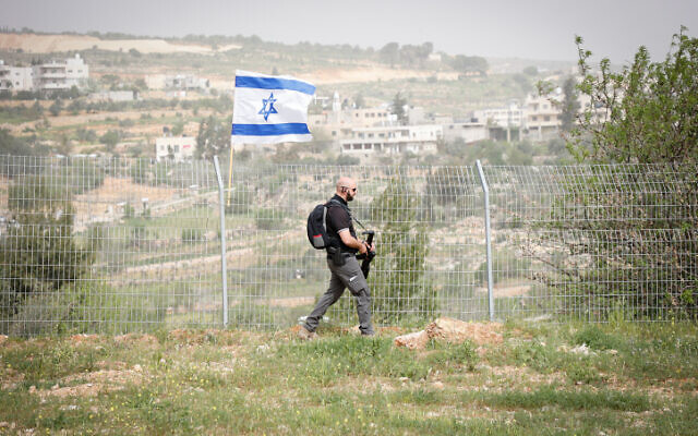 A security guard patrols the fence around the West Bank settlement of Efrat on April 8, 2022. (Gershon Elinson/FLASH90) A security guard patrols the fence around the West Bank settlement of Efrat on April 8, 2022. (Gershon Elinson/FLASH90)