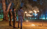 A ceremony marking Remembrance Day for Israel's fallen soldiers and victims of terror, in Moshav Yashresh, on May 3, 2022. The sign reads "Yizkor" or "in memoriam." (Yossi Aloni/Flash90)