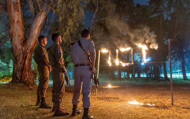 A ceremony marking Remembrance Day for Israel's fallen soldiers and victims of terror, in Moshav Yashresh, on May 3, 2022. The sign reads "Yizkor" or "in memoriam." (Yossi Aloni/Flash90) A ceremony marking Remembrance Day for Israel's fallen soldiers and victims of terror, in Moshav Yashresh, on May 3, 2022. The sign reads "Yizkor" or "in memoriam." (Yossi Aloni/Flash90)