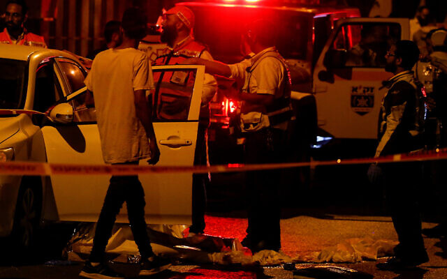Security and rescue personnel work at the scene of a terror attack, in Elad, May 5, 2022. (Jamal Awad/Flash90) Security and rescue personnel work at the scene of a terror attack, in Elad, May 5, 2022. (Jamal Awad/Flash90)
