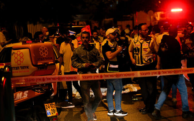 Security and rescue personnel work at the scene of a terror attack, in Elad, May 5, 2022. (Jamal Awad/Flash90) Security and rescue personnel work at the scene of a terror attack, in Elad, May 5, 2022. (Jamal Awad/Flash90)