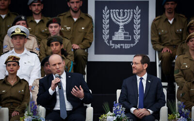 Prime Minister Naftali Bennett (L) and President Isaac Herzog and Prime Minister Naftali Bennett attend an event for outstanding soldiers, as part of Israel's 74th Independence Day celebrations, at the President's Residence in Jerusalem, on May 5, 2022. (Yonatan Sindel/Flash90) Prime Minister Naftali Bennett (L) and President Isaac Herzog and Prime Minister Naftali Bennett attend an event for outstanding soldiers, as part of Israel's 74th Independence Day celebrations, at the President's Residence in Jerusalem, on May 5, 2022. (Yonatan Sindel/Flash90)