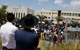 Ultra-Orthodox Jews attend funeral service in Elad for Yonatan Havakuk and Boaz Gol, killed the night before in a terrorist ax attack, on May 6, 2022. (Olivier Fitoussi/Flash90)