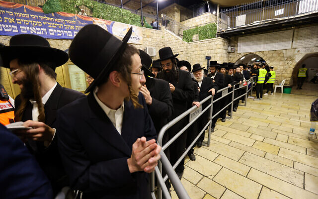 Ultra-Orthodox Jews shuffle past the tomb of Rabbi Shimon Bar Yochai as they attend Lag B'Omer celebrations on Mount Meron in northern Israel on May 18, 2022. (David Cohen/Flash90)