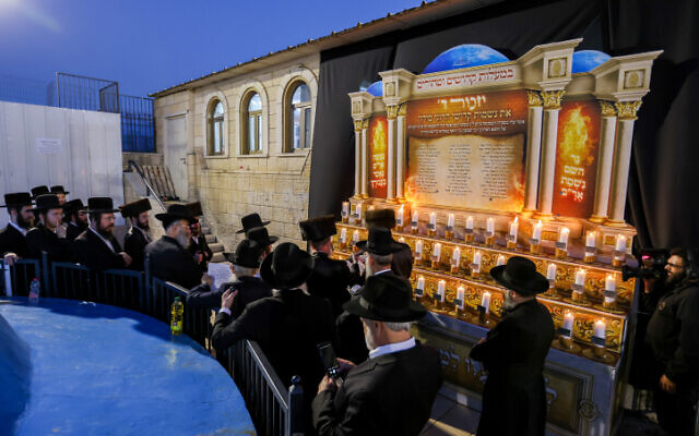 Grand Rabbi of Boyan Hasidic dynasty lights candles in memory of the 45 lost lives at last year's Mount Meron disaster, during Lag B'Omer celebrations, in Meron on May 18, 2022 (David Cohen/Flash90)