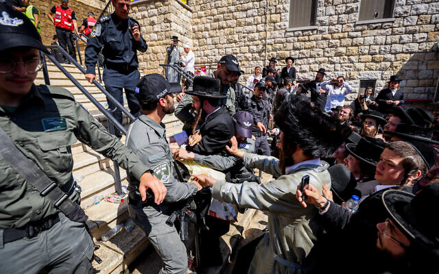 Ultra-Orthodox pilgrims clash with police during Lag B'Omer celebrations, in Mount Meron, on May 19, 2022. (David Cohen/Flash90)