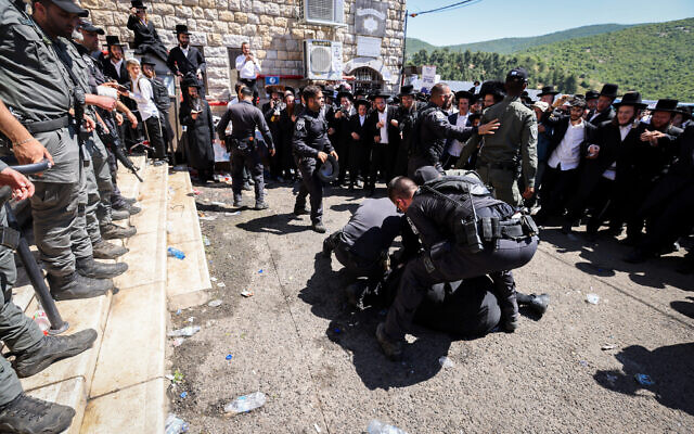 Ultra-Orthodox pilgrims clash with police during Lag B'Omer celebrations, in Mount Meron, on May 19, 2022. (David Cohen/Flash90)