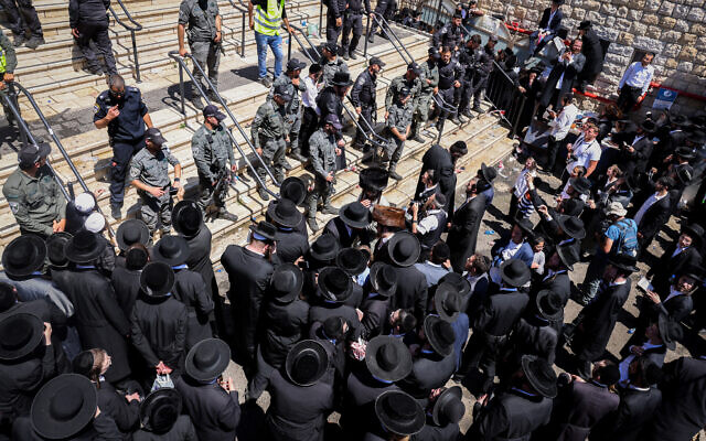 Ultra-Orthodox pilgrims clash with police during Lag B'Omer celebrations at Mount Meron in northern Israel on May 19, 2022. (David Cohen/Flash90)