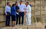 Israeli forensic team members open Uziel Khoury's grave to take a DNA sample at the Segula Cemetery in Petah Tikva on May 23, 2022. (Avshalom Sassoni/Pool via Flash90)