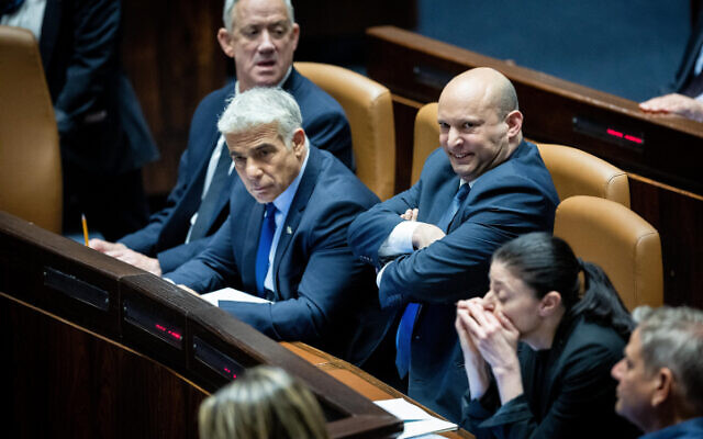Prime Minister Naftali Bennett, Foreign Minister Yair Lapid and Defense Minister Benny Gantz attend a plenum session in the Knesset on May 23, 2022. (Yonatan Sindel/Flash90)