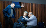 Ra'am leader Mansour Abbas (right) speaks with Foreign Minister Yair Lapid (center) and Ra'am MK Walid Taha during a plenum session in the Knesset, in Jerusalem, on May 23, 2022. (Yonatan Sindel/Flash90)