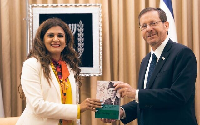 Pakistani-American Anila Ali gives a book to President Isaac Herzog during a rare trip by a Pakistani national to Israel in May. (Twitter) Pakistani-American Anila Ali gives a book to President Isaac Herzog during a rare trip by a Pakistani national to Israel in May. (Twitter)