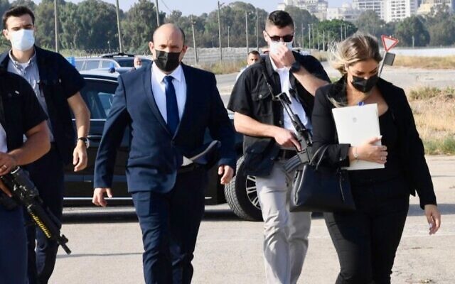 Prime Minister Naftali Bennett strolls with aide Naomi Sasson (right), whose resignation was announced on May 30, 2022. (Courtesy) Prime Minister Naftali Bennett strolls with aide Naomi Sasson (right), whose resignation was announced on May 30, 2022. (Courtesy)