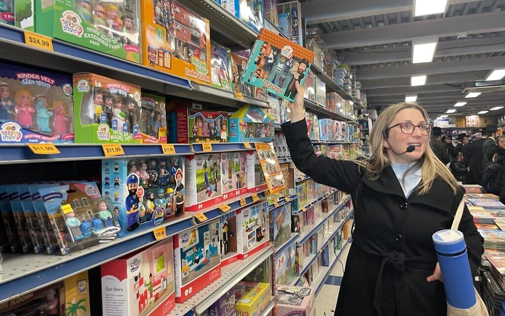Frieda Vizel speaks to tour-takers in a Hasidic toy store in Williamsburg, New York, April 2022. (Danielle Ziri)