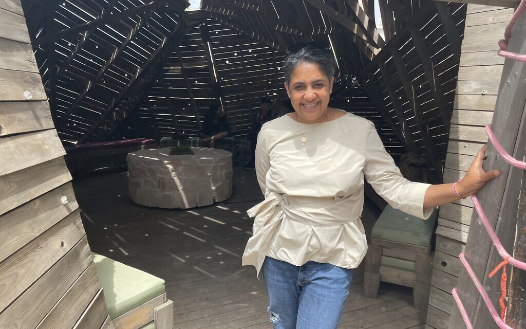 Visiting Indian artist Vibha Galhotra, at the entrance of the wooden meditation temple at Jerusalem's Muslala, with the stone altar in back of her, at its center, created as part of her 10-week residency in the Jerusalem International Fellows, through May 2022 (Jessica Steinberg/Times of Israel) Visiting Indian artist Vibha Galhotra, at the entrance of the wooden meditation temple at Jerusalem's Muslala, with the stone altar in back of her, at its center, created as part of her 10-week residency in the Jerusalem International Fellows, through May 2022 (Jessica Steinberg/Times of Israel)