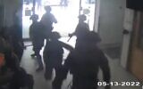 Israeli police officers are seen in Saint Joseph's Hospital in Jerusalem, from where Al Jazeera journalist Shireen Abu Akleh's funeral set out, on May 16, 2022. (Screen capture: Twitter)