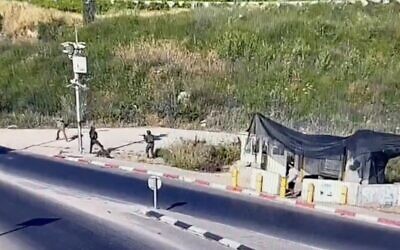 A screenshot of surveillance video shows Palestinian man armed with a knife charging at Israeli soldiers before being shot, May 17, 2022. (Screen capture: Twitter)
