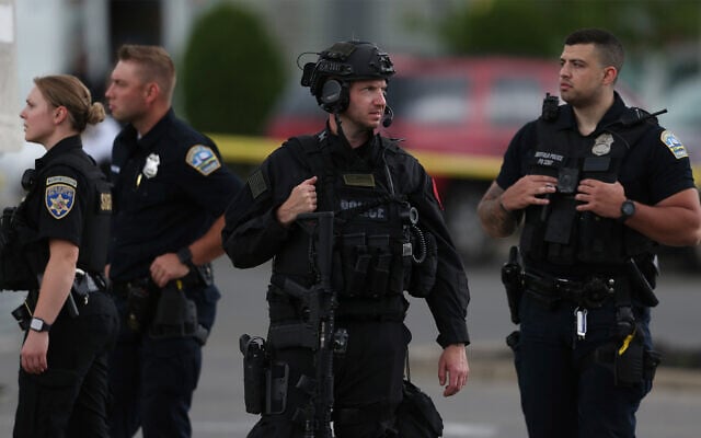 Police walk along the perimeter of the scene after a shooting at a supermarket in Buffalo, New York, May 14, 2022. (AP Photo/Joshua Bessex) Police walk along the perimeter of the scene after a shooting at a supermarket in Buffalo, New York, May 14, 2022. (AP Photo/Joshua Bessex)