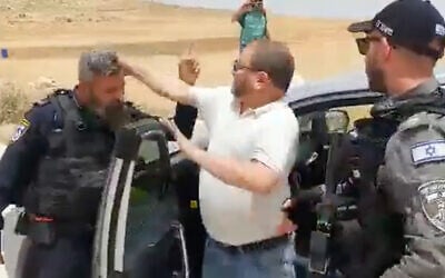 Then-Joint List Knesset member Ofer Cassif appears to hit a police officer in the West Bank on May 13, 2022. (Screenshot)