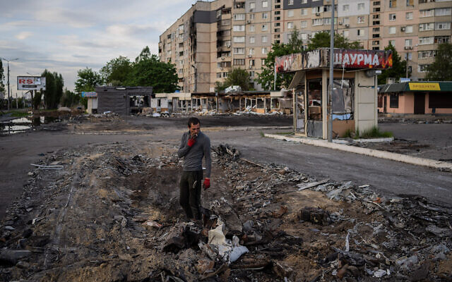 A man searches for metal scraps in a shelled neighborhood in Kharkiv, eastern Ukraine, May 19, 2022. (AP Photo/Bernat Armangue) A man searches for metal scraps in a shelled neighborhood in Kharkiv, eastern Ukraine, May 19, 2022. (AP Photo/Bernat Armangue)