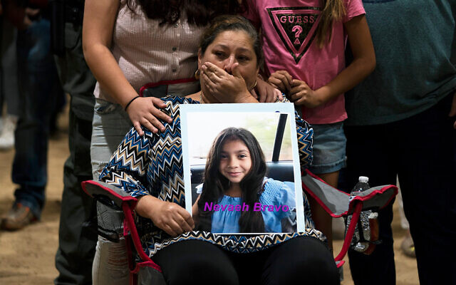 Esmeralda Bravo, 63, sheds tears while holding a photo of her granddaughter, Nevaeh, one of the Robb Elementary School shooting victims, during a prayer vigil in Uvalde, Texas, May 25, 2022. (AP Photo/Jae C. Hong) Esmeralda Bravo, 63, sheds tears while holding a photo of her granddaughter, Nevaeh, one of the Robb Elementary School shooting victims, during a prayer vigil in Uvalde, Texas, May 25, 2022. (AP Photo/Jae C. Hong)