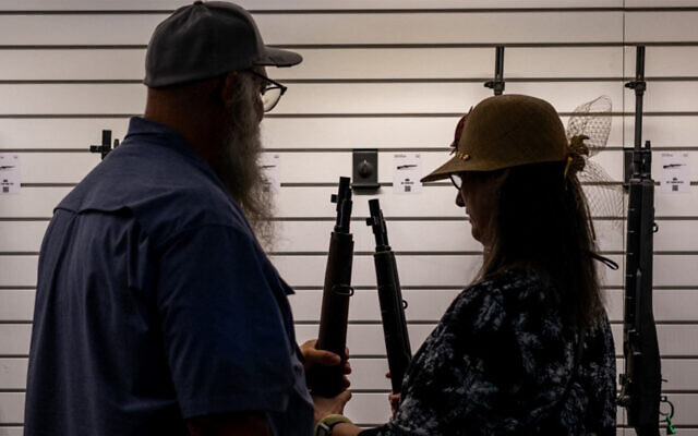 A couple examines a rifle at the George R. Brown Convention Center during the National Rifle Association (NRA) annual convention on May 27, 2022 in Houston, Texas. (Brandon Bell/Getty Images/AFP) A couple examines a rifle at the George R. Brown Convention Center during the National Rifle Association (NRA) annual convention on May 27, 2022 in Houston, Texas. (Brandon Bell/Getty Images/AFP)