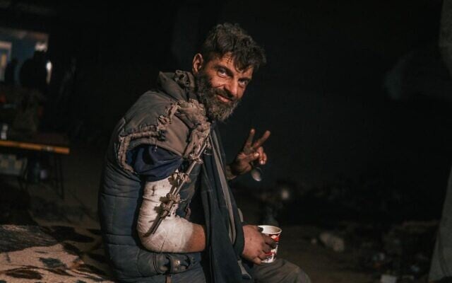 A wounded Ukrainian soldier defending the besieged Azovstal plant flashes a victory sign, May 11, 2022 ( A wounded Ukrainian soldier defending the besieged Azovstal plant flashes a victory sign, May 11, 2022 (