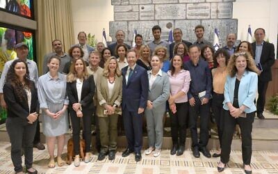 President Isaac Herzog and his wife Michal (to his right) pose with members of the President's Climate Forum, at the President's Residence in Jerusalem on May 17, 2022. Dov Khenin is third from right. (Amos Ben-Gershom/GPO)